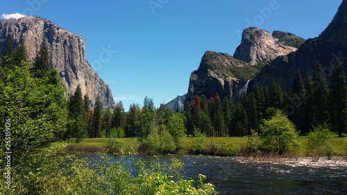 Yosemite National Park. Yosemite Valley View vista point. Merced river on foreground, El Capitan on the left and bridaveil falls on right on background.