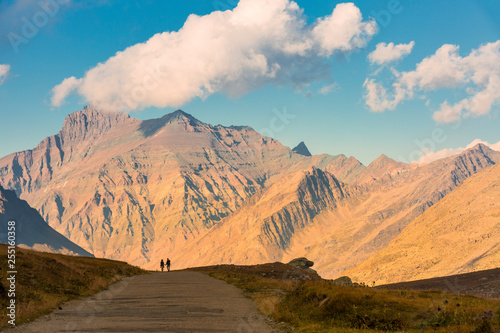 Hikers silhouette at Nivolet plateau and Grivola in the background, Nivolet pass, Graian Alps, Gran Paradiso National Park, Piedmont region, Italy photo