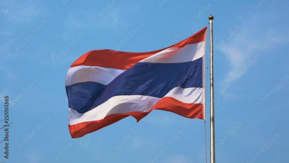The national flag of Thailand has three colors, consisting of red, white and blue on the flagpole with the wind blowing and having a sky background. slow motion The national flag of Thailand has three colors, consisting of red, white and blue on the flagpole with the wind blowing and having a sky background. slow motion