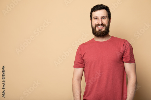 Young bearded man laughing, studio shot.