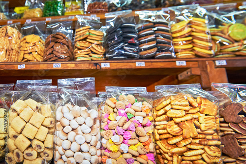 Different kind of coockies packed in clear plastic bags standing on a shelve at a stall at the Klong Toey Market in Bangkok, Thailand