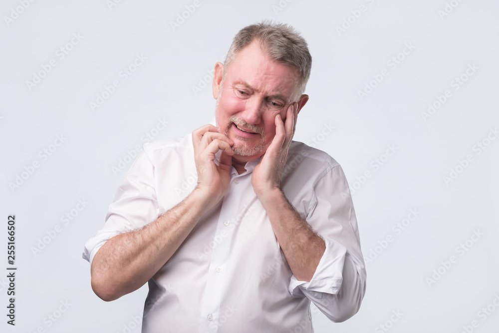 Sad senior man in white shirt thinking abour life. Sad senior man in white shirt thinking abour life.