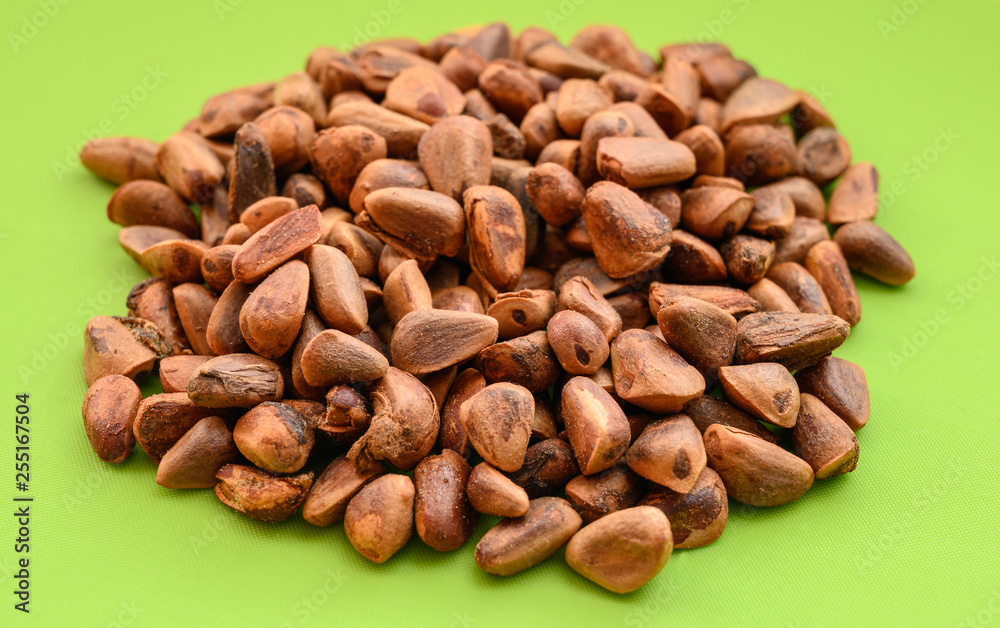 Pile of walnut on green background. Pile of walnut on green background.