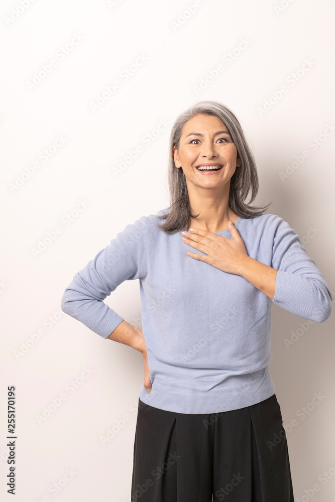Charming Asian woman posing on the white background. Charming Asian woman posing on the white background.