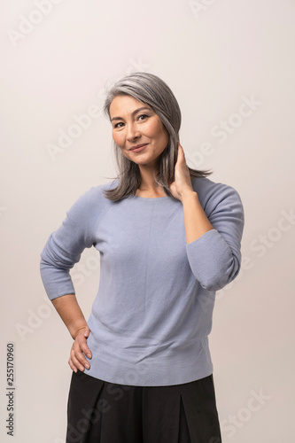 Εκτύπωση καμβά Smiling Asian woman touches her grey hair