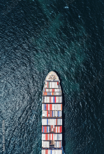 Aerial top view container ship full load container on the deep sea for logistic, import export, shipping or transportation.