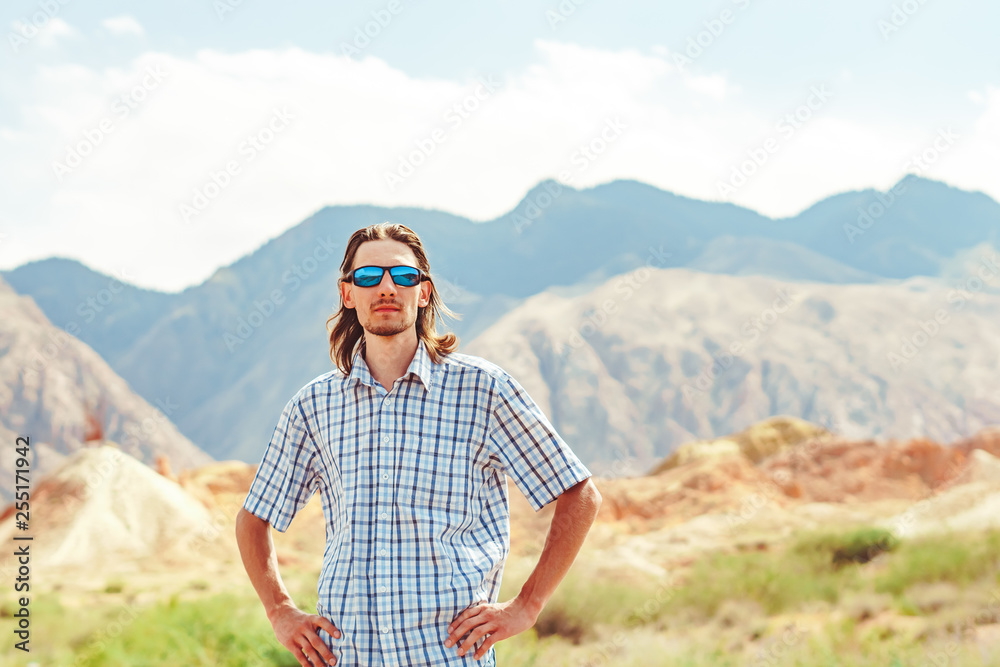 the guy standing on a background of mountains the guy standing on a background of mountains