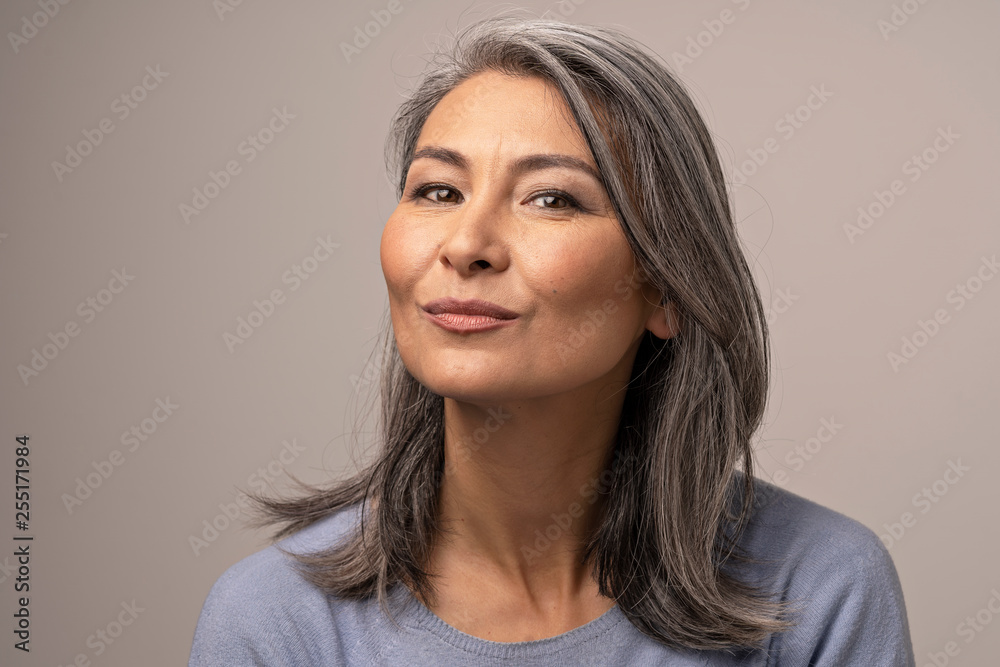 Charming Asian mature woman smiles at camera Charming Asian mature woman smiles at camera