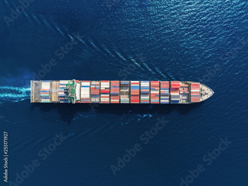 Aerial top view container ship full load container from at sea port for logistics, import export, shipping or transportation.