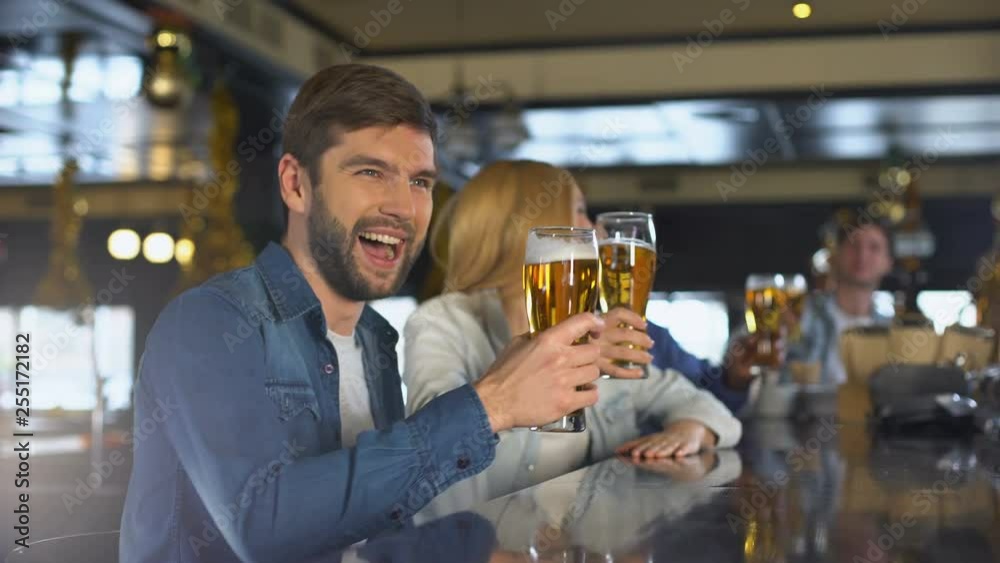 Friends enjoying sport program in bar, drinking for victory, beer traditions Friends enjoying sport program in bar, drinking for victory, beer traditions