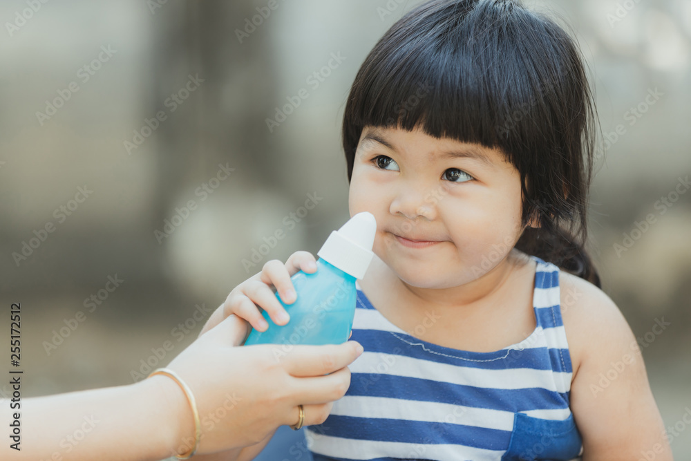 Adorable girl cleaning nose for health care. Adorable girl cleaning nose for health care.