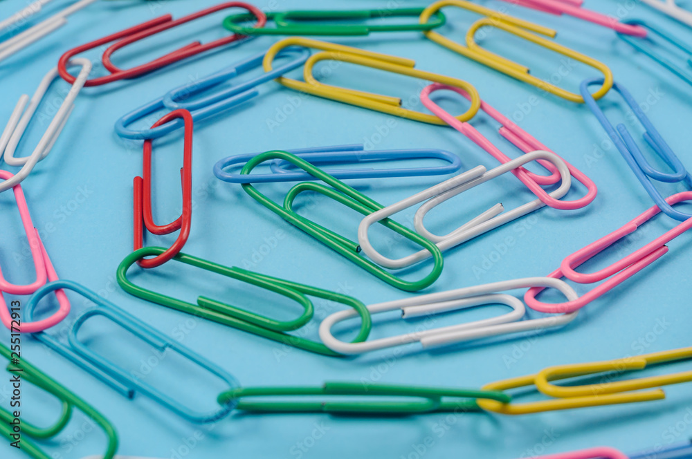 Chain made of paper clips on blue background. Teamwork and cooperation concept. Soft focus. Chain made of paper clips on blue background. Teamwork and cooperation concept. Soft focus.