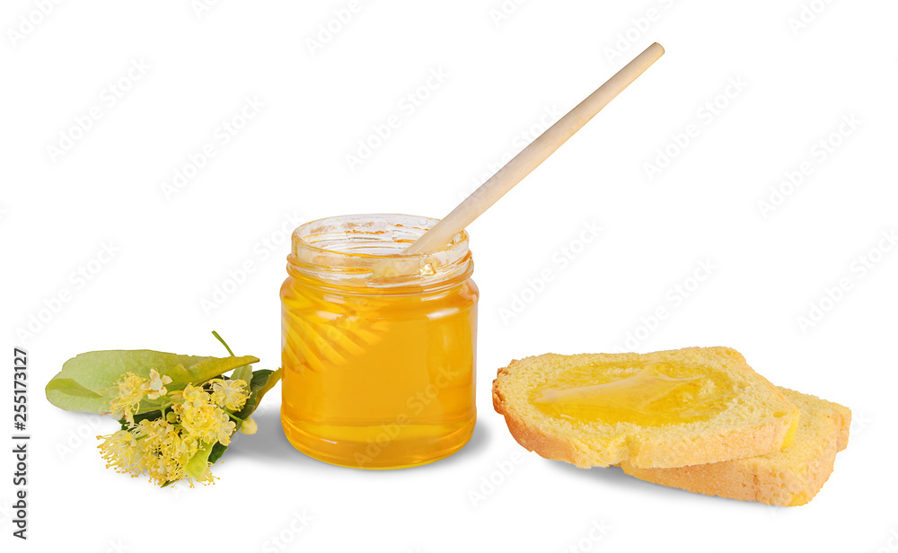 Jar of linden honey with wooden dipper, slices of corn bread and linden flowers isolated on white background Jar of linden honey with wooden dipper, slices of corn bread and linden flowers isolated on white background