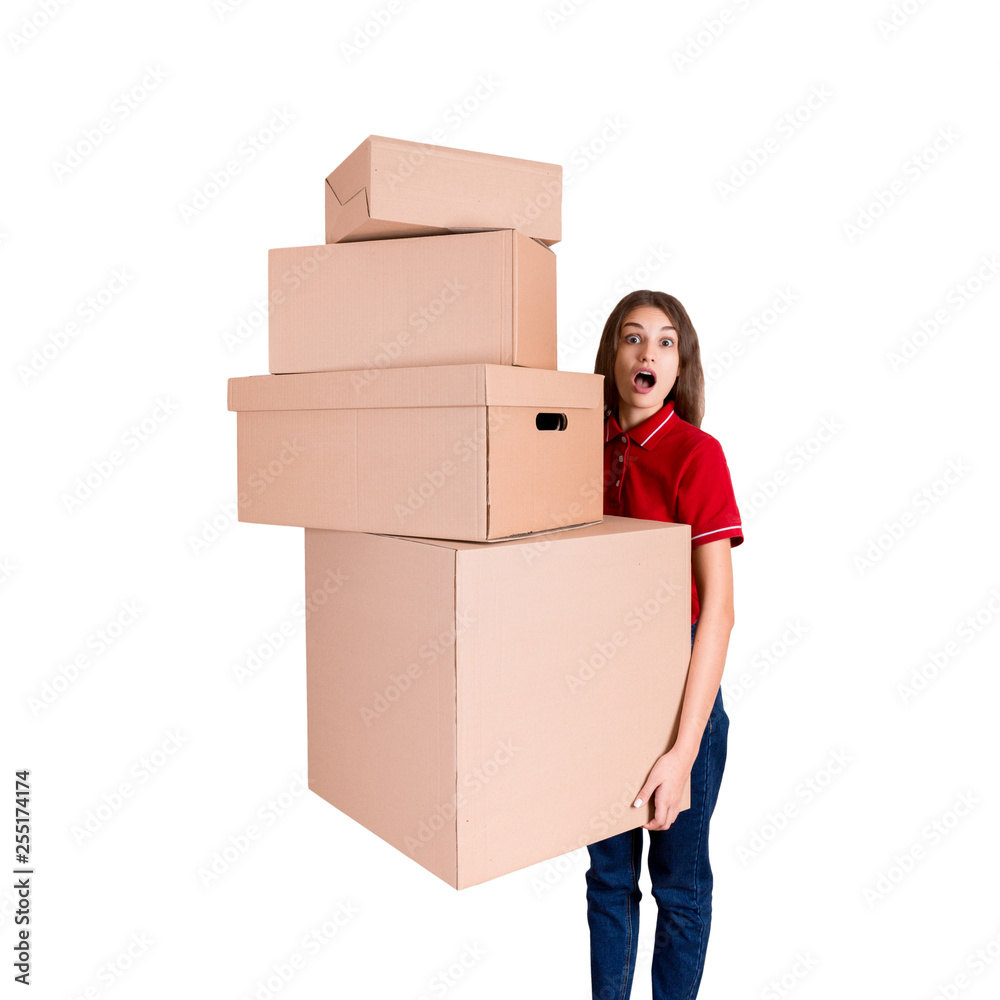 Shocked woman is looking at a heap of boxes with a widely open mouth isolated on white background Shocked woman is looking at a heap of boxes with a widely open mouth isolated on white background