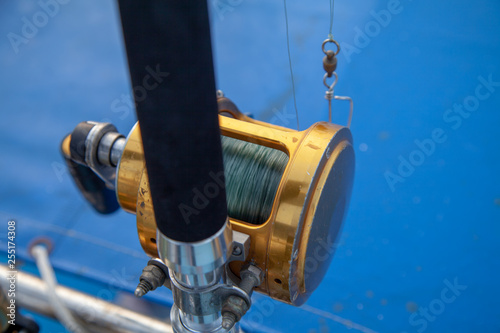 trolling rods and reels for sea fishing on a boat against the sea