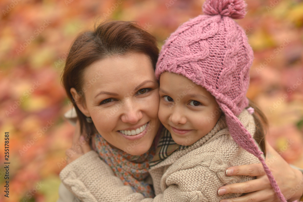 Portrait of cute mother with daughter in autumn park Portrait of cute mother with daughter in autumn park
