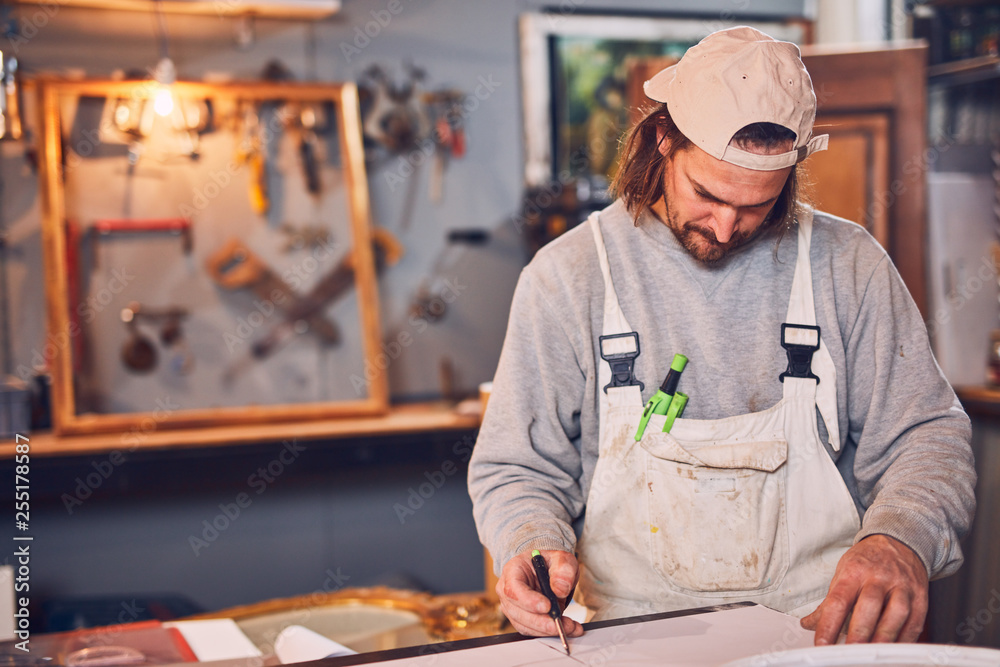Male carpenter fixing old wood in a retro vintage workshop. Male carpenter fixing old wood in a retro vintage workshop.
