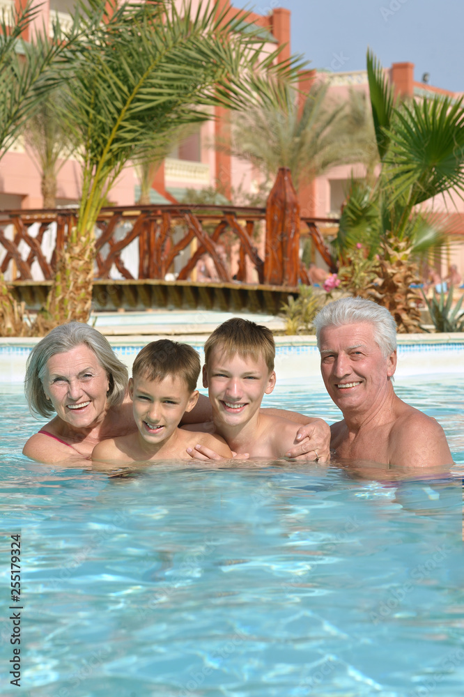 Portrait of happy elderly couple with grandsons