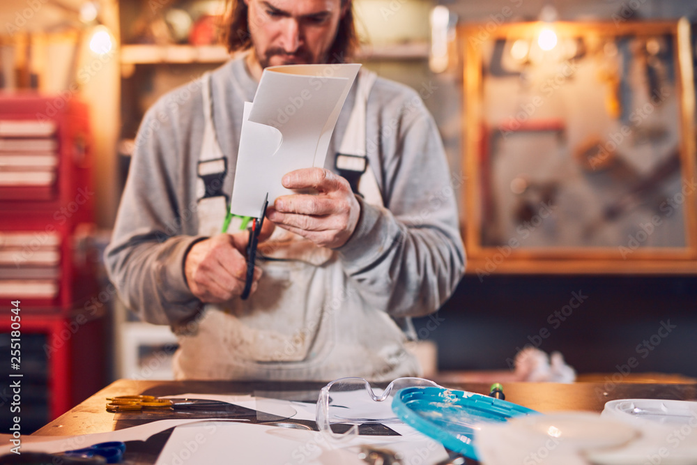 Male carpenter fixing old wood in a retro vintage workshop. Male carpenter fixing old wood in a retro vintage workshop.