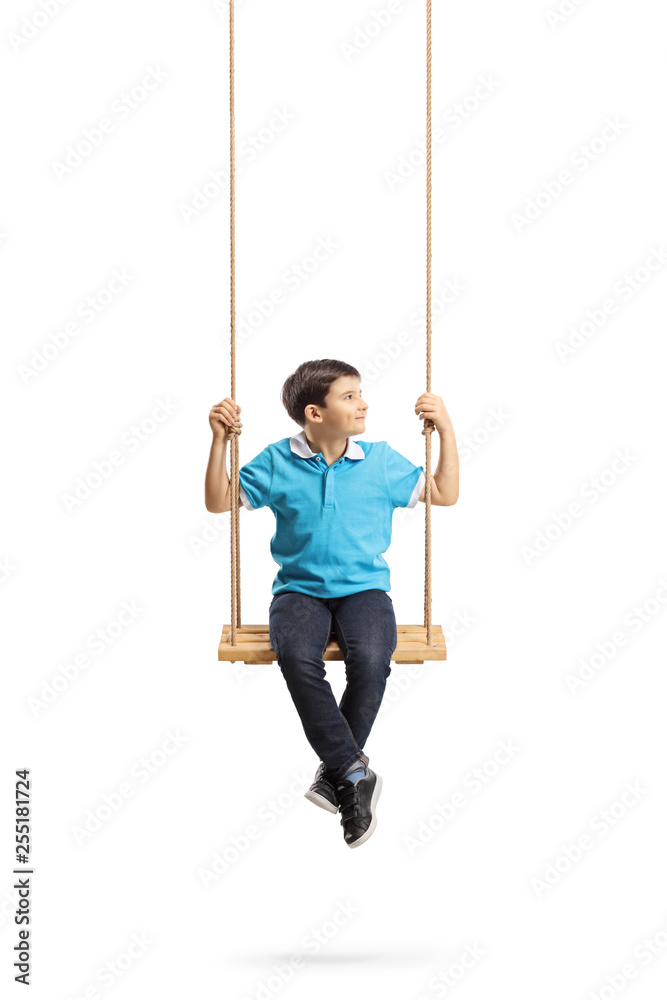 Little boy sitting on a swing and looking to the side Little boy sitting on a swing and looking to the side