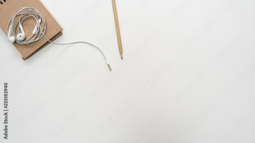Office desk table with notebook and earphone close up Top view copy space Office desk table with notebook and earphone close up Top view copy space