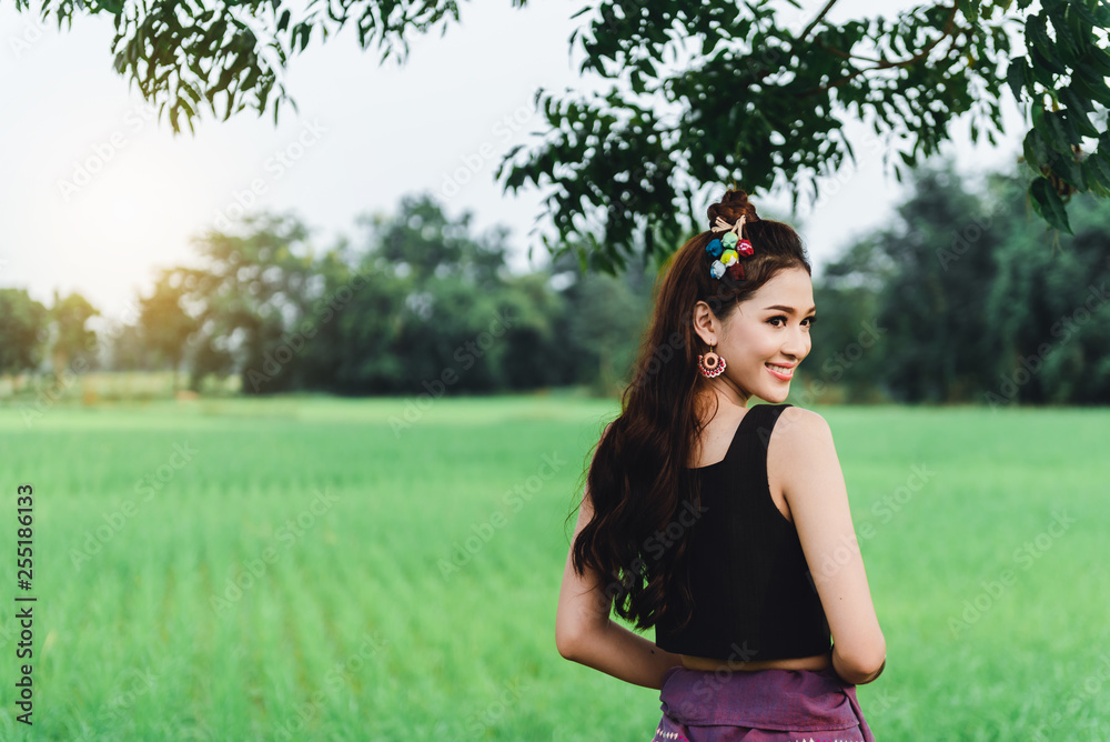 Beautiful Asian woman in local dress standing and enjoy natural on bamboo bridge in rice field Beautiful Asian woman in local dress standing and enjoy natural on bamboo bridge in rice field