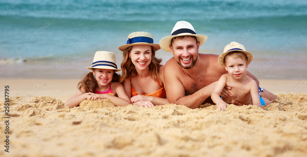 happy family father, mother and children on beach at sea. happy family father, mother and children on beach at sea.