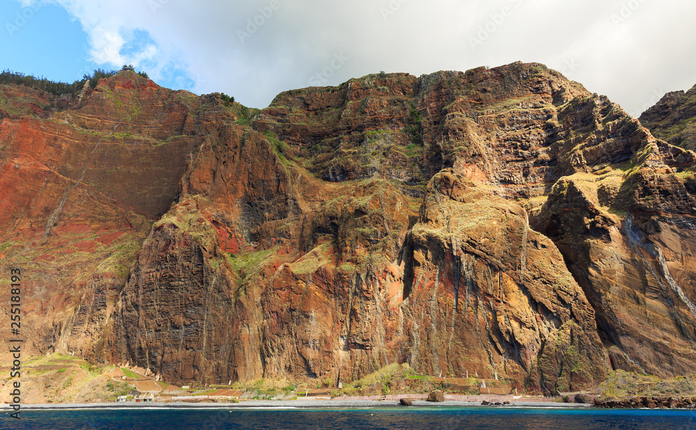 Beautiful view of the big cliffs of the island Madeira, seen from the Atlantic ocean, with the Cabo Girao viewpoint on top