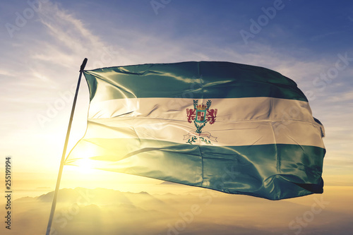 Masaya department of Nicaragua flag waving on the top sunrise mist fog photo