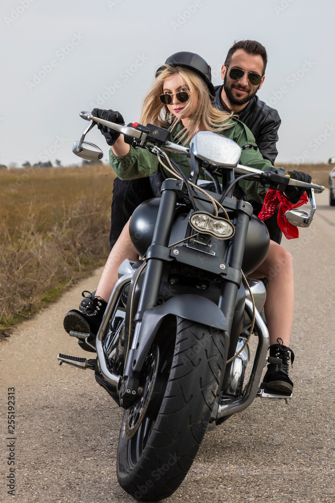 Beautiful young couple traveling Motorbike Beautiful young couple traveling Motorbike