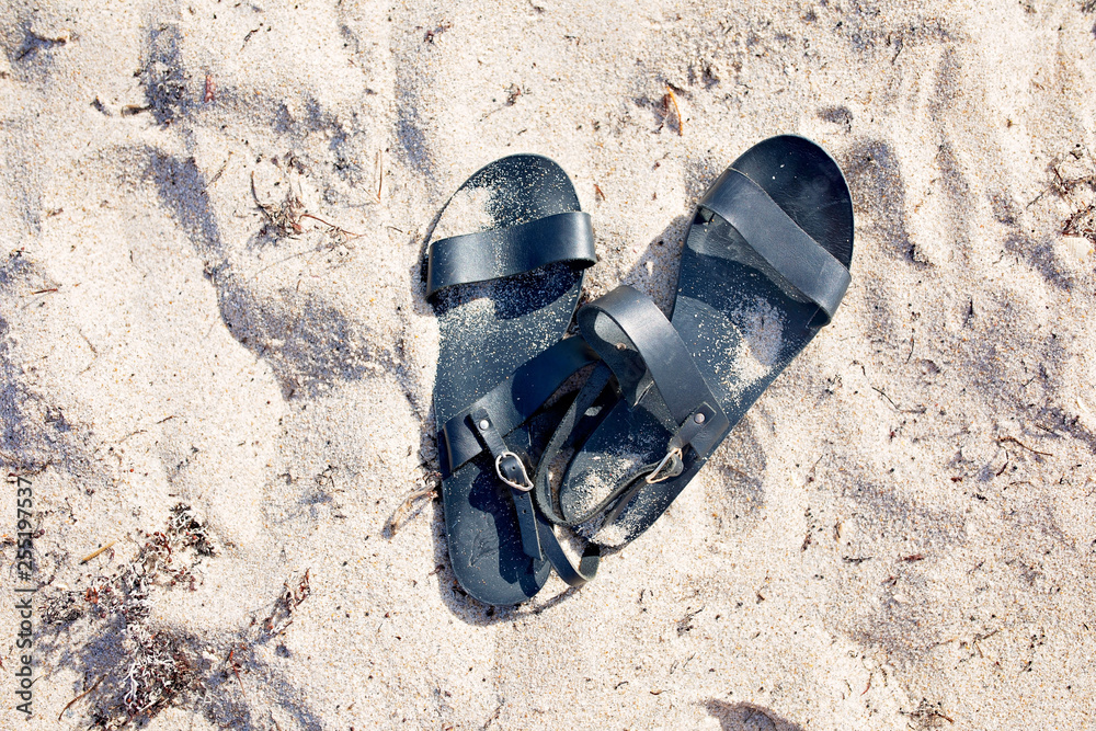 Fototapeta premium Sandals on the Beach Sand
