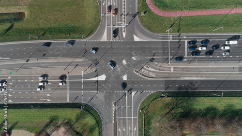 Highway intersection with cars and traffic lights. Top view from drone