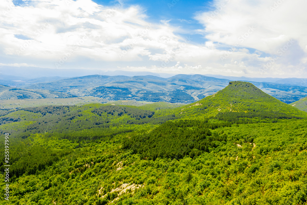 landscape of mountains and valleys of the Crimean Peninsula overlooking the mountain resembling a pyramid