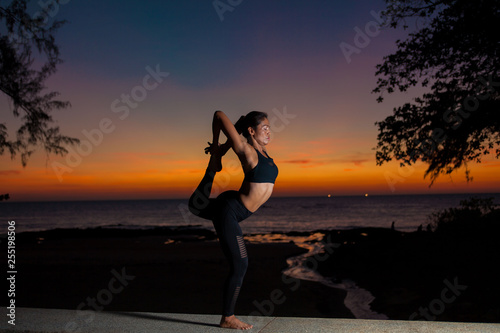  silhouette practicing yoga on sunset