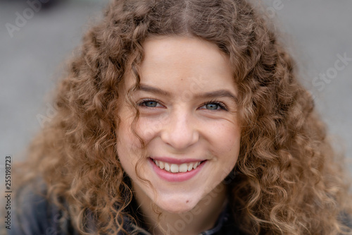 Close up of happy woman with curly hair