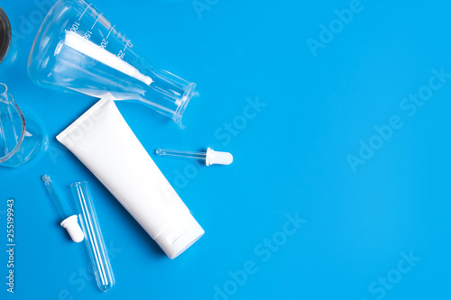 top view close up science and treatment cream lotion aromatic beauty cosmetic skincare with test tube and mockup product on blue table white background