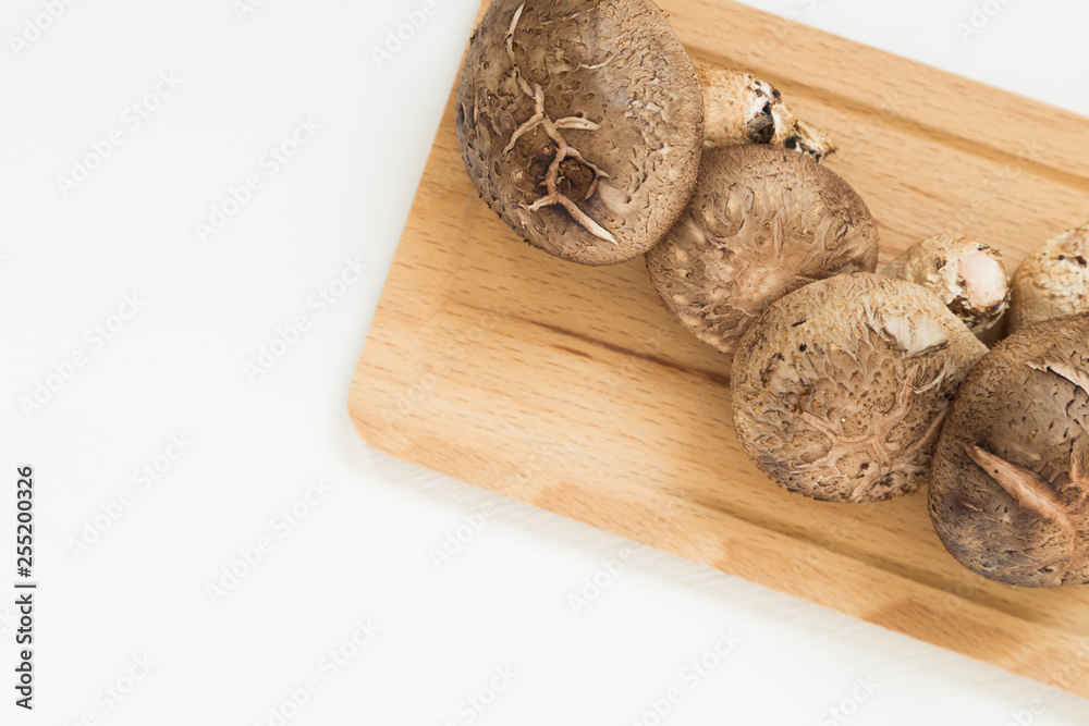 Fresh mushrooms on wooden tray isolated on white background Fresh mushrooms on wooden tray isolated on white background