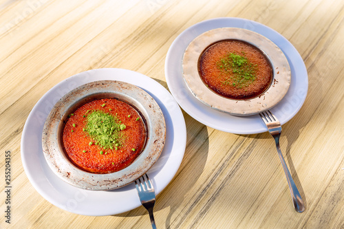 Turkish traditional dessert kunefe with cheese, served hot photo