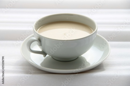 cup of coffee with froth on a white background.