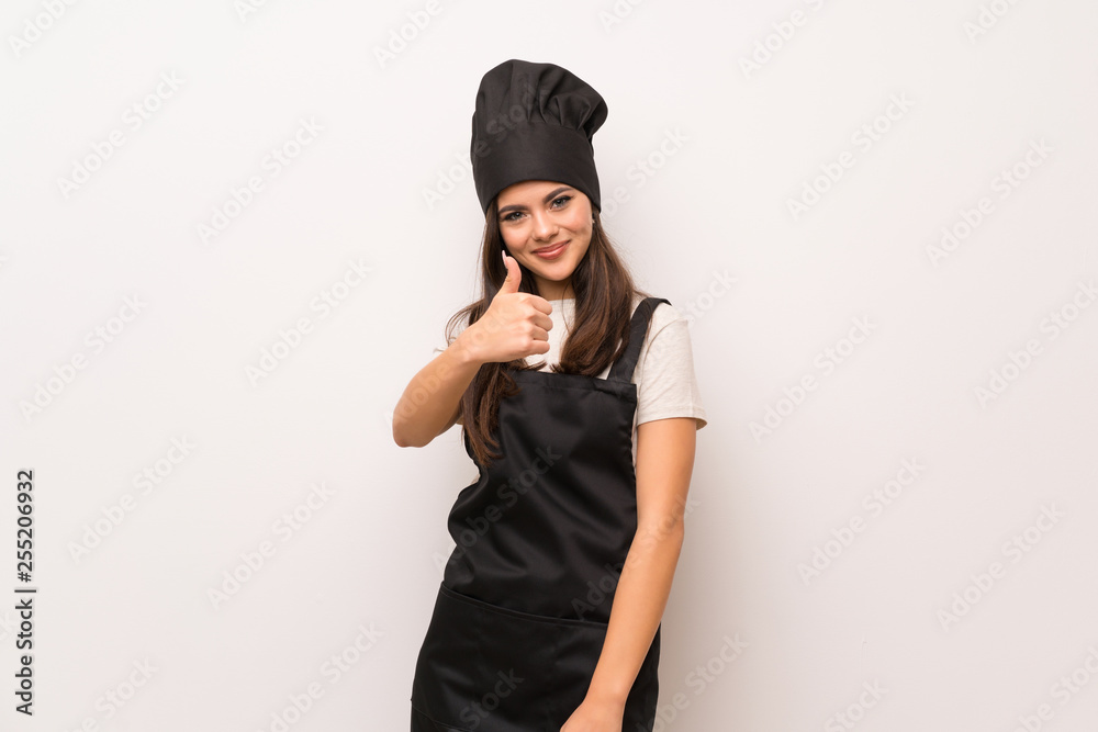 Teenager chef over white wall with thumbs up because something good has happened Teenager chef over white wall with thumbs up because something good has happened