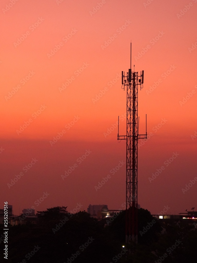 Radio tower on sunset background.