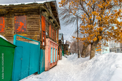 snow-covered old wooden and brick houses