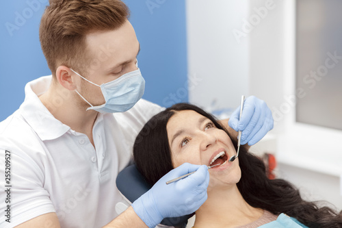 Best dentist in town. Professional dentist examining teeth of his senior female patient at the dental clinic profession job occupation career health medical doctor checkup stomatology hygiene concept