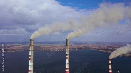 Aerial view of old thermoelectric plant with big chimneys in a rural landscape near the reservoir photo