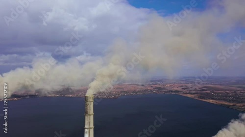 Aerial view of old thermoelectric plant with big chimneys in a rural landscape near the reservoir photo