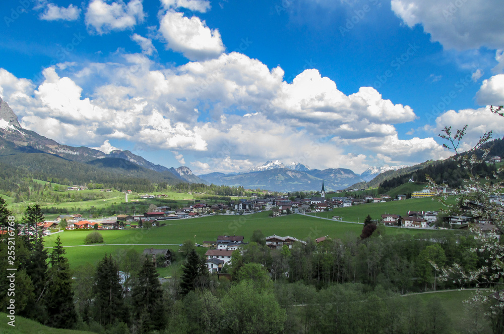 Panorama from the village of Elmau -Tyrol near the city of Innsbruck with green sunny Austrian Alps in Tyrol with snowy mountains in the background under blue sky