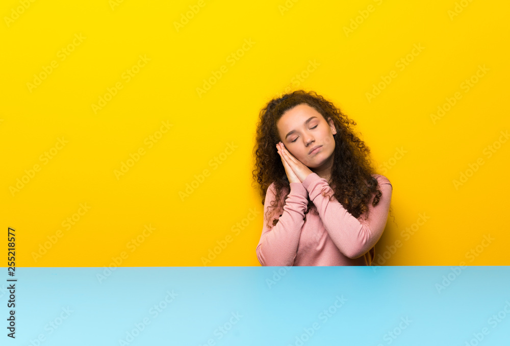 Teenager girl making sleep gesture in dorable expression Teenager girl making sleep gesture in dorable expression