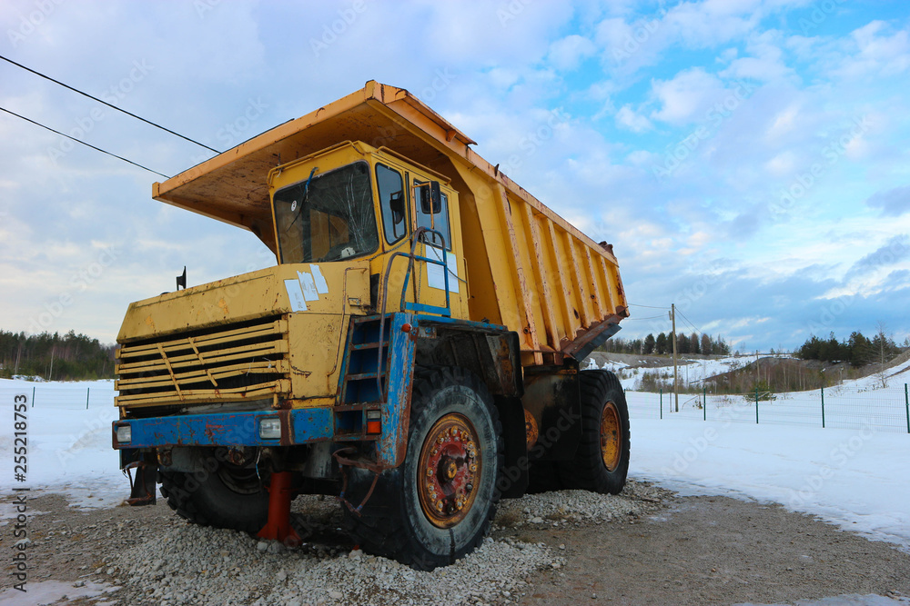 old hard worker - big old yellow dump truck on the snow old hard worker - big old yellow dump truck on the snow