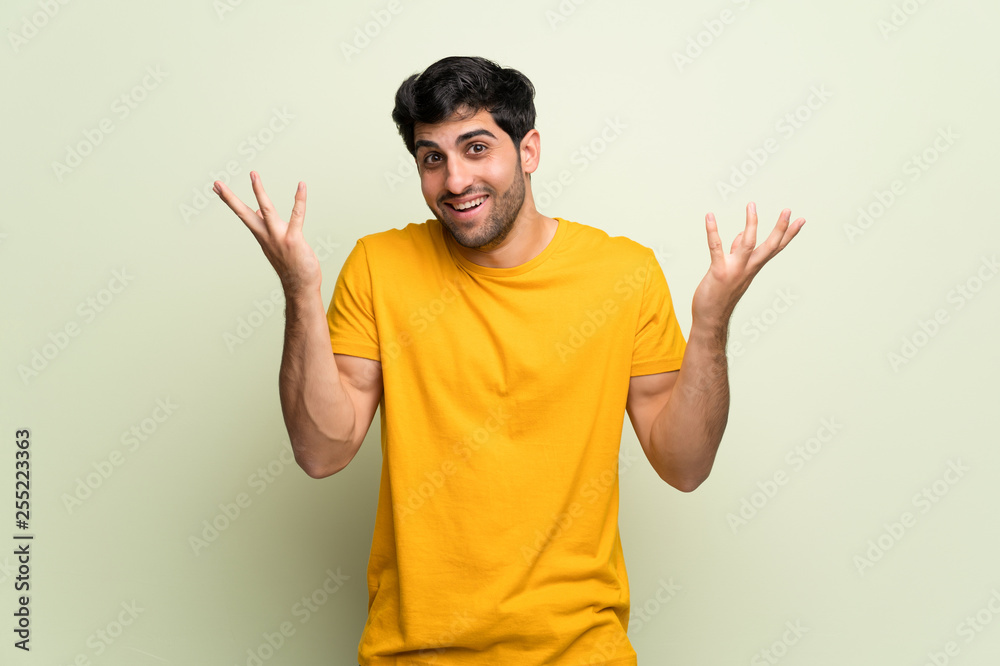 Young man over pink wall smiling with a sweet expression Young man over pink wall smiling with a sweet expression