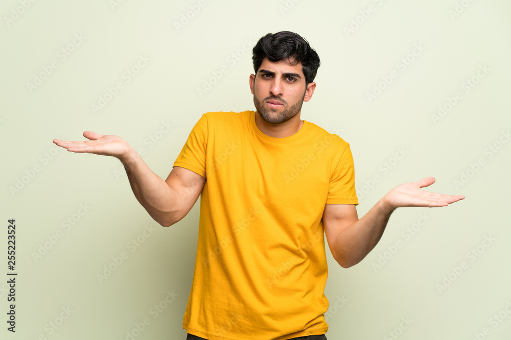 Young man over pink wall unhappy and frustrated with something because not understand something Young man over pink wall unhappy and frustrated with something because not understand something
